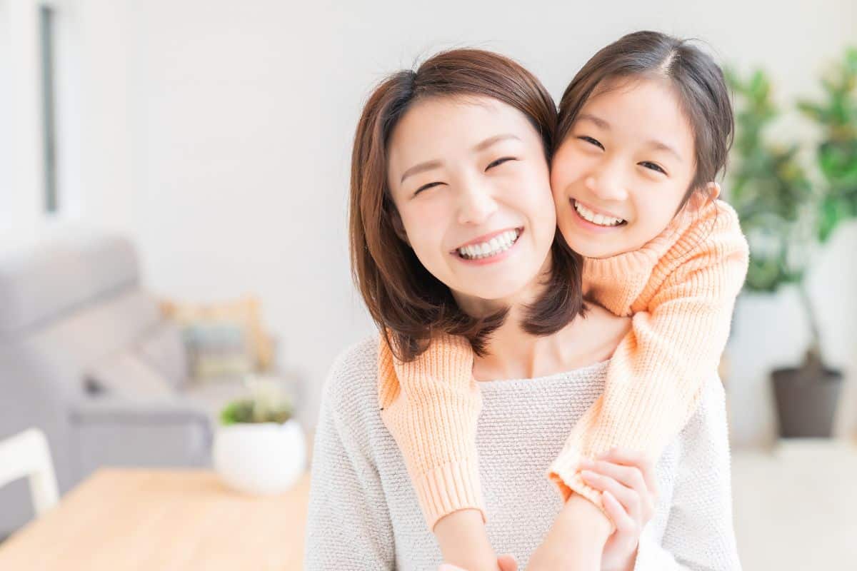 Mom and daughter hugging happily clean teeth gum disease periodontal health