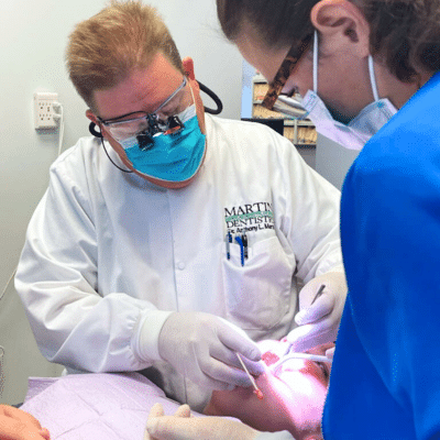 Martin-our-story-blog Dentists working on a patient's teeth, representing dentistry in yorktown, va