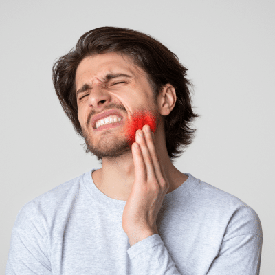 A man with a toothache, representing cosmetic dental problems