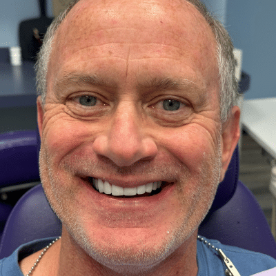 A male patient smiling, representing what to expect at a dental cleaning